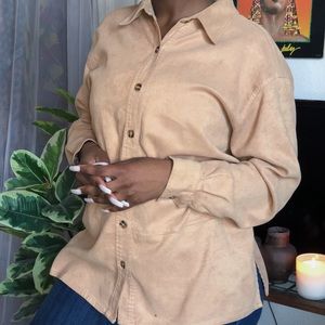 Soft tan polyester and spandex button up.